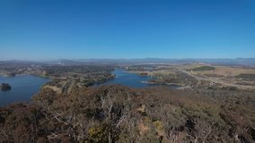 Rising high above beautiful Australian bush land overlooking Canberra with lake Burley Griffin in the distance.