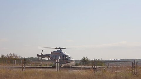 Air rescue service. Helicopter air ambulance is ready for take off at the heliport. Cooperation between air rescue service and emergency medical service on the ground. Helicopter take off.