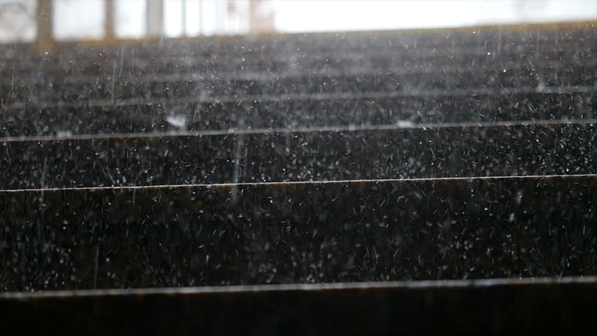 Heavy rain falling on marble steps in slow motion. 4k, 3840x2160