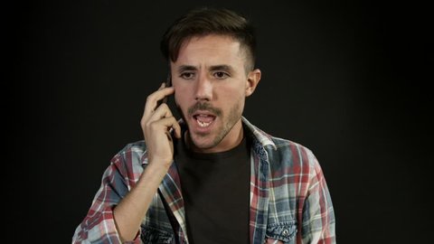 Angry and annoyed man screaming into mobile phone, arguing