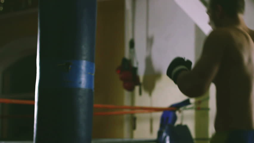 Young boxer trains on punching bag