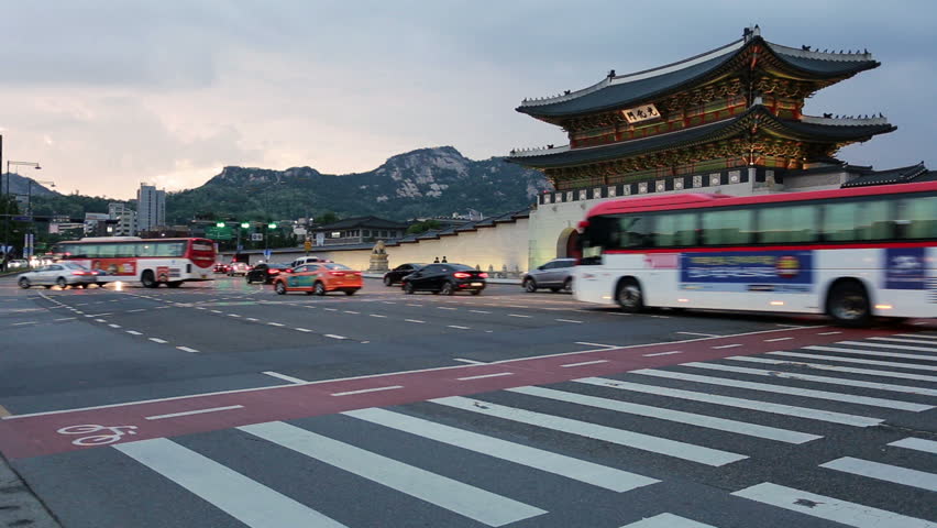 Time lapse of traffic rushing at night in front of the Gwanghawmun gate in front of the Gyeongbokgung palace in the heart of historic Seoul, South Korea capital city.
