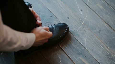 Man successfully ties his dress shoes.