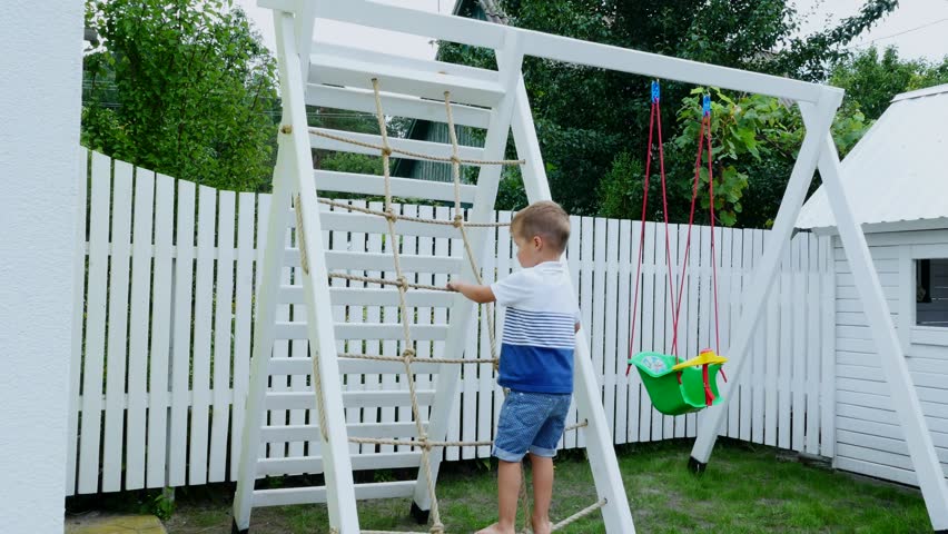 summer, in the garden, child, a four year old boy climbs the children