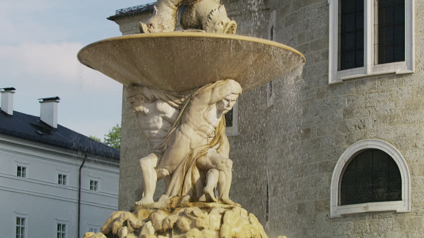 Medium slow motion shot of water flowing from fountain / Salzburg, Austria