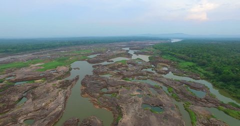 aerial photography around grand canyon in Mekong river. 3000 bok mean 3000 holes,holes eroded into the rock along Mekong river. color of water inside the holes after low tide is emerald green 