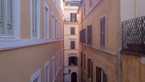 Aerial view, drone flying over small old european street, Rome Italy. Old, vintage windows.