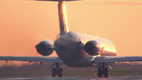  Aircraft taking off at sunset. Long shot 