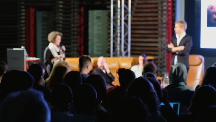 Audience listens to the lecturer at the conference hall