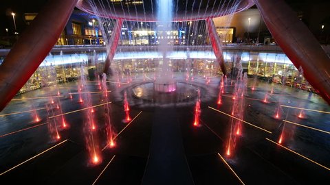 SINGAPORE - AUG 22, 2017 : Light show of the fountain of Wealth with Suntec Towers on august 22, 2017 in Singapore. Fountain of wealth located Suntec Towers, Singapore.