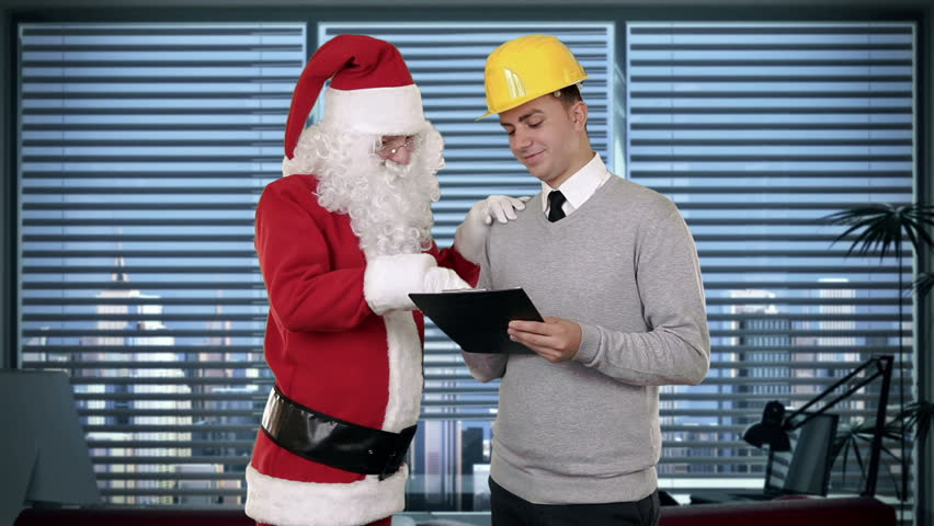Santa Claus and Young Architect in a modern office