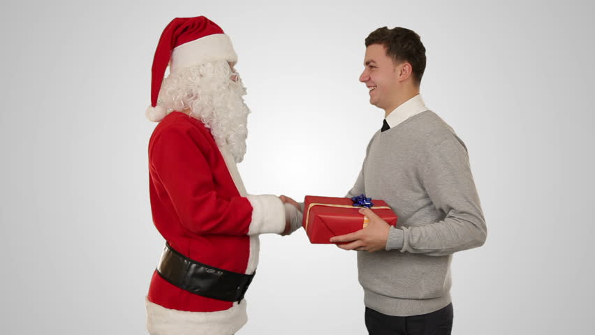 Young Businessman receiving a present from Santa Claus, shaking hands, against