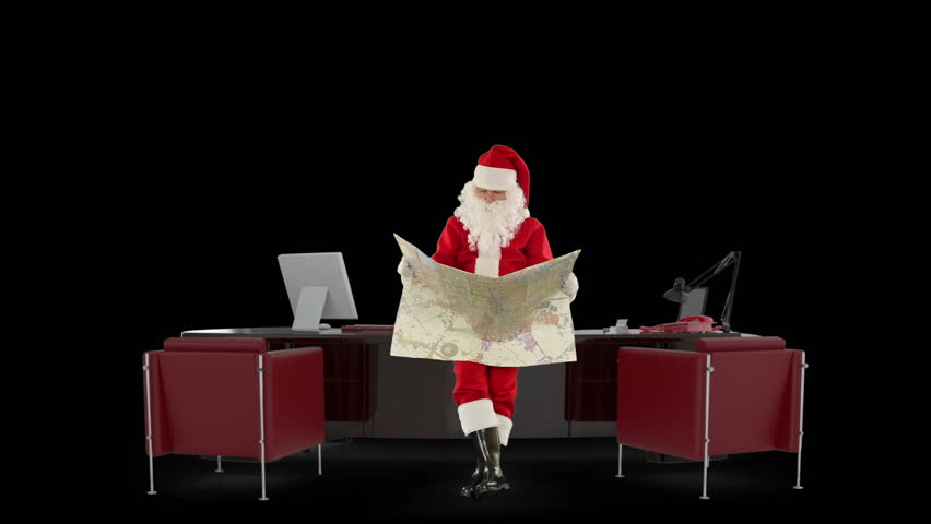 Santa Claus reading a map in his modern Christmas Office, against black