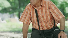 Close up shot of serious elderly man sitting in park / Kazanluk, Bulgaria