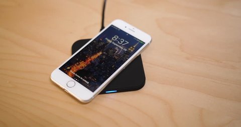 Circa September, 2017 - An iPhone 8 is placed on a wireless Qi charger station. The 8th generation iPhone was the first to offer wireless charging.