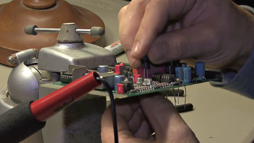 Close-up of a technician's actions - replacing components (in this case