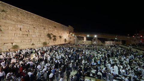 Timelapse - Sunrise at the prayer plaza wall in Jerusalem the western wall at Yom Kippur the day of Atonement, praying people asking for forgiveness 
