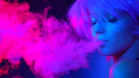 Fashion art portrait of beauty model woman in bright lights with colorful smoke. Smoking girl, Close up of a female inhaling from an electronic cigarette. Night life concept. 4K UHD Slow motion video 