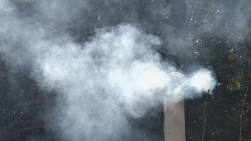A stovepipe chimney exhausts wood smoke from a wood-burning stove into the air