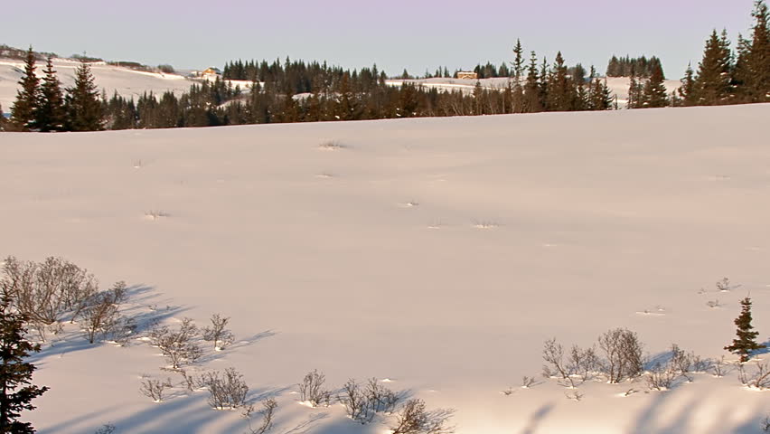 Time-lapse of a spiral labyrinth made by a man walking in snow shoes in a snowy