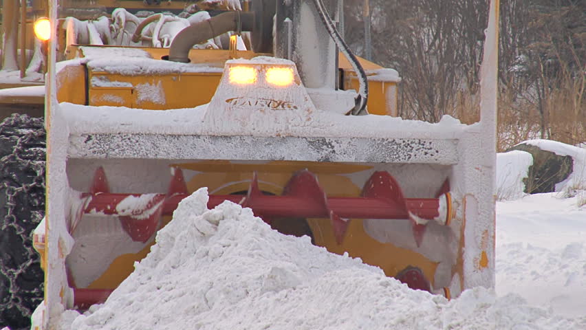 Close-up of snow blower vanes, pull back to show entire scene.