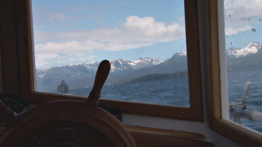 Boating in a small boat on Kachemak Bay, Kenai Mountains beyond. A view of the