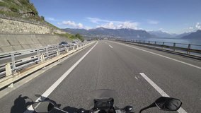 Point of view video of a motorcycle driving on the highway above Montreux in Canton Vaud by lake Geneva and the alps mountain in Switzerland.