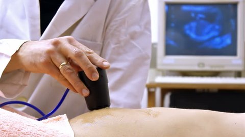 Doctor performs an ultrasound examination of the patient