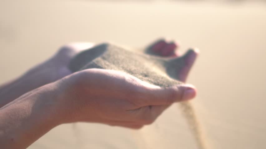 Close up of woman pouring sand running through fingers slow motion at the beach with sun flare Royalty-Free Stock Footage #31270555