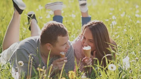 Romantic couple with ice cream at amusement park.