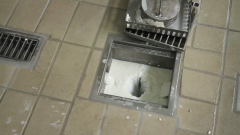 Footage of milk waste in a milk factory going down the drain...