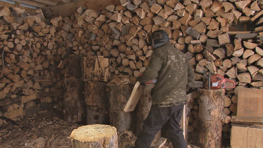 Careless or clumsy woodsman in the wood shed splitting kindling with sloppy axe