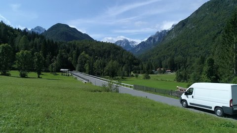 Aerial - Delivery van transporting cargo on a beautiful road through the countryside in Slovenia