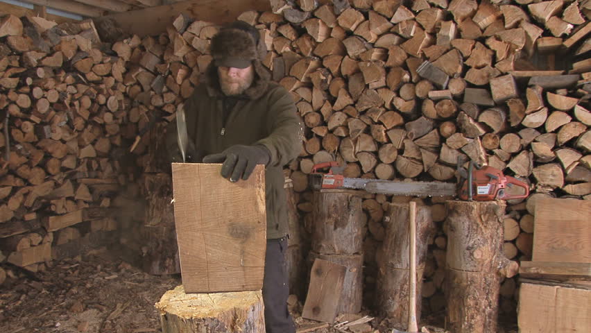 Careless or clumsy woodsman in the wood shed splitting kindling with sloppy axe
