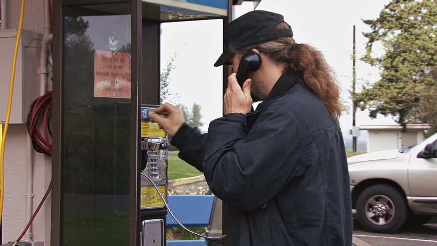 Man using pay phone