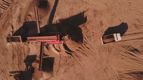Aerial view of loading sand into trucks