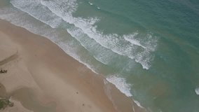 Aerial drone footage ,drone on 50meter high capture ocean waves reaching shore 