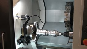 4K video footage of CNC lathe machine, close up view of metal processing