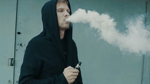 Man smoking electronic cigarette vapor. Smoking Electronic Cigarette, Vape, Man Vaping