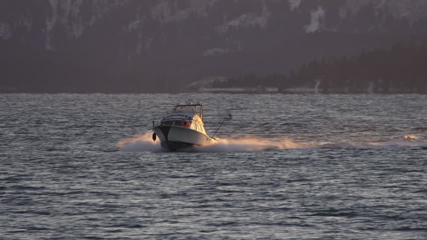 HOMER, AK - CIRCA 2012: A small cabin cruiser fishing boat blasting its way