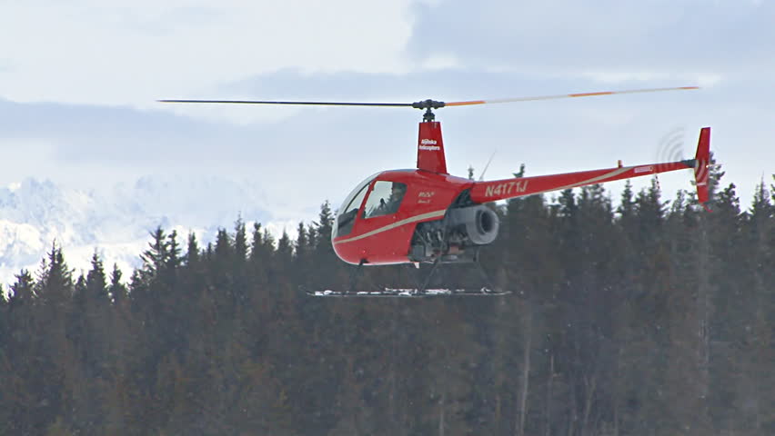 ANCHORAGE, AK - CIRCA 2012: Red 2-man helicopter (Robinson R22) slowly ascending