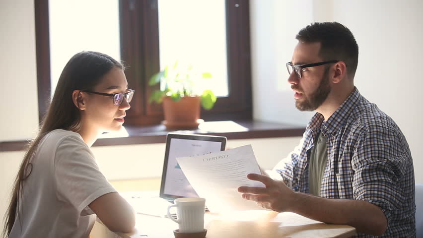 Man and woman arguing disagreeing about bad business contract, colleagues having conflict dispute about document sitting at office desk, partners shouting breaking agreement with unacceptable terms Royalty-Free Stock Footage #31313920