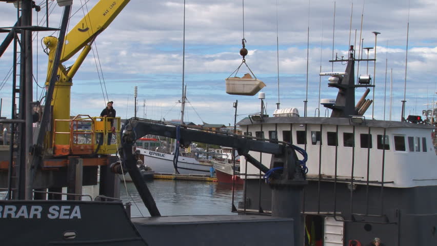 HOMER, AK - CIRCA 2011: Fishing vessel resupply via crane.