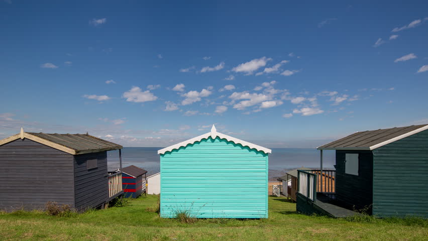 Time lapse of traditional english beach huts in whistable, kent, england on a summer