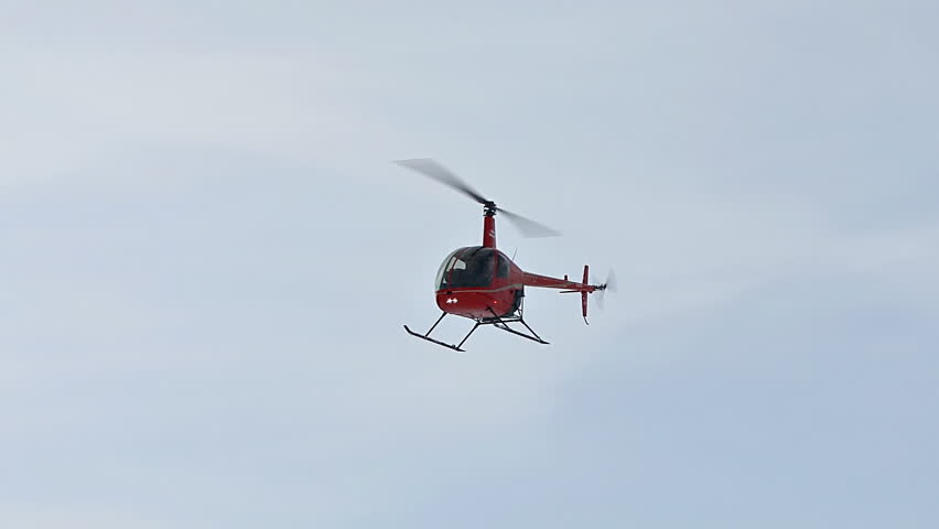 HOMER, AK CIRCA 2012: Red 2-man helicopter (Robinson R22) flying above,