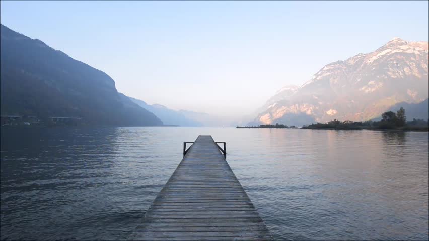 Wooden jetty extends far into the lake. Evening mood.  Lake Lucerne.