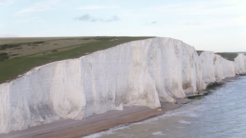 Dramatic aerial reveal at speed of white chalk cliffs of Beachy Head Beachy Head and shore line in the UK