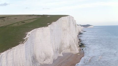 Beautiful close range aerial of white chalk cliffs showing waves gently breaking near Seven Sisters and Beachy Head