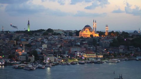 Eventide in Istanbul. View from Galata Tower to Old Istanbul. Looking over Golden Horn to Suleymaniye Mosque, in distance famous landmarks such as Beyazit Tower and Eminonu motor port. 