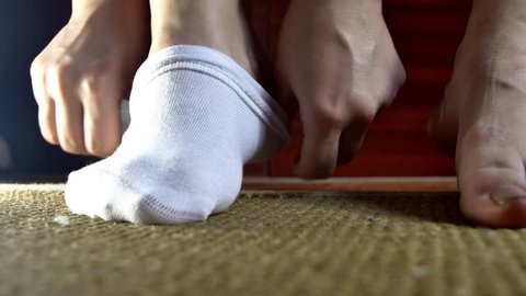Young Woman Putting On A Pair Of White Socks, Morning, Bedroom, Dressing Up